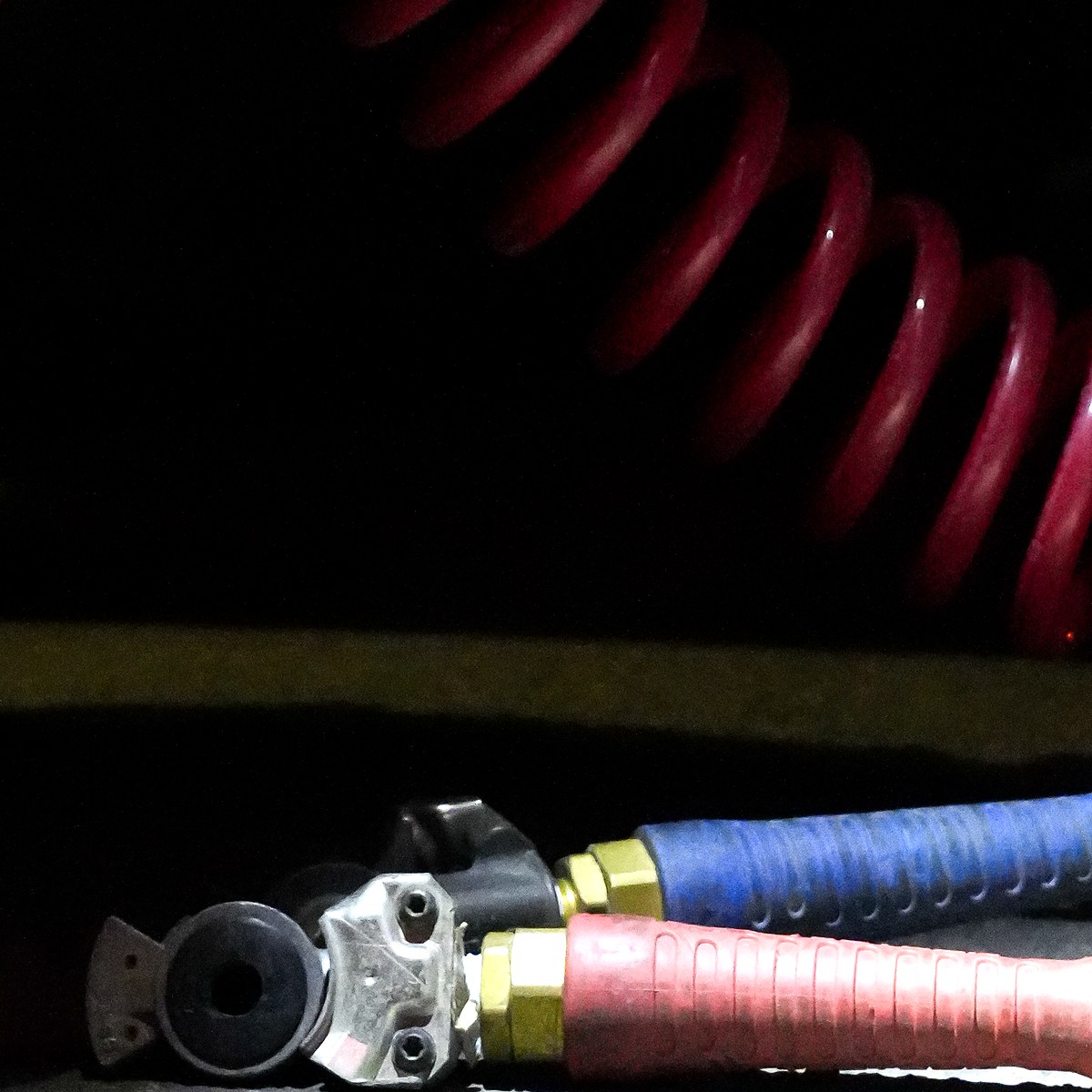 Gladhand pair on red and blue air lines below a coiled red air line, at the back of a truck