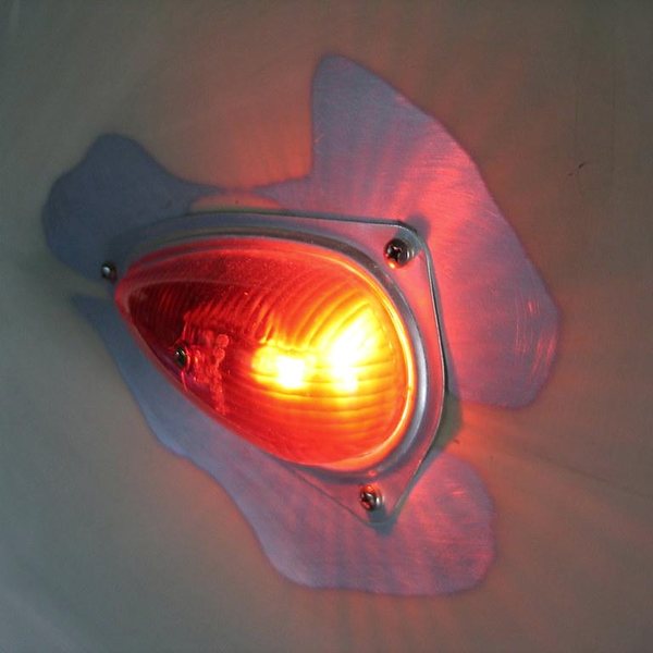 Round amber LED marker light in a chrome housing on a trailer