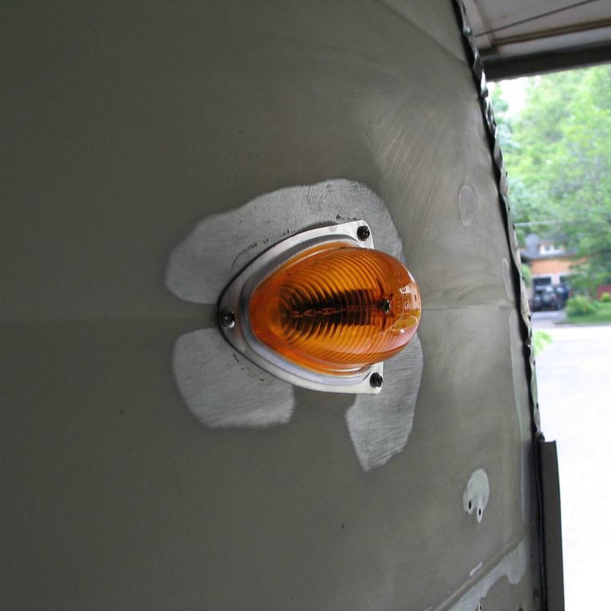 Amber LED marker light on the side rail of a trailer