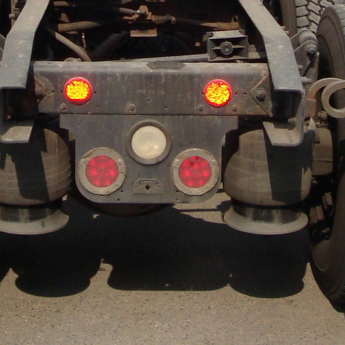 Rear of a tractor with red taillights and amber marker lights