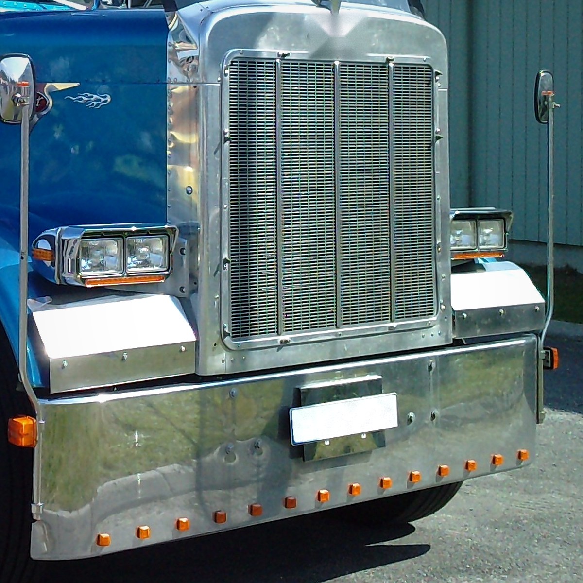 Chrome truck bumper lined with small amber marker lights