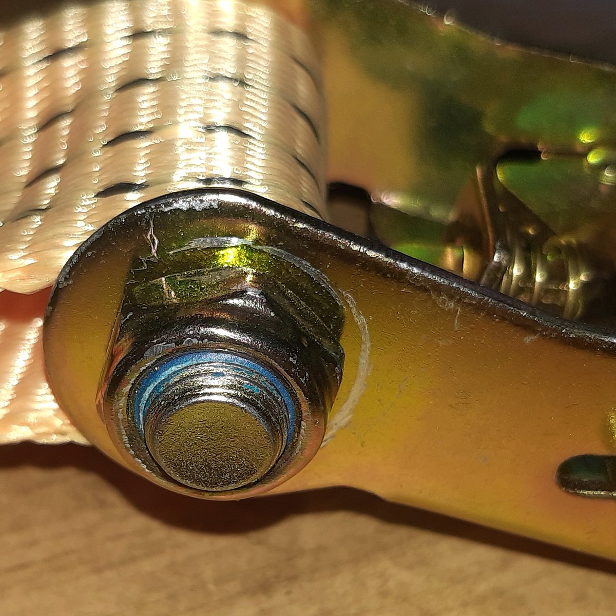 Yellow polyester webbing wound on a steel ratchet